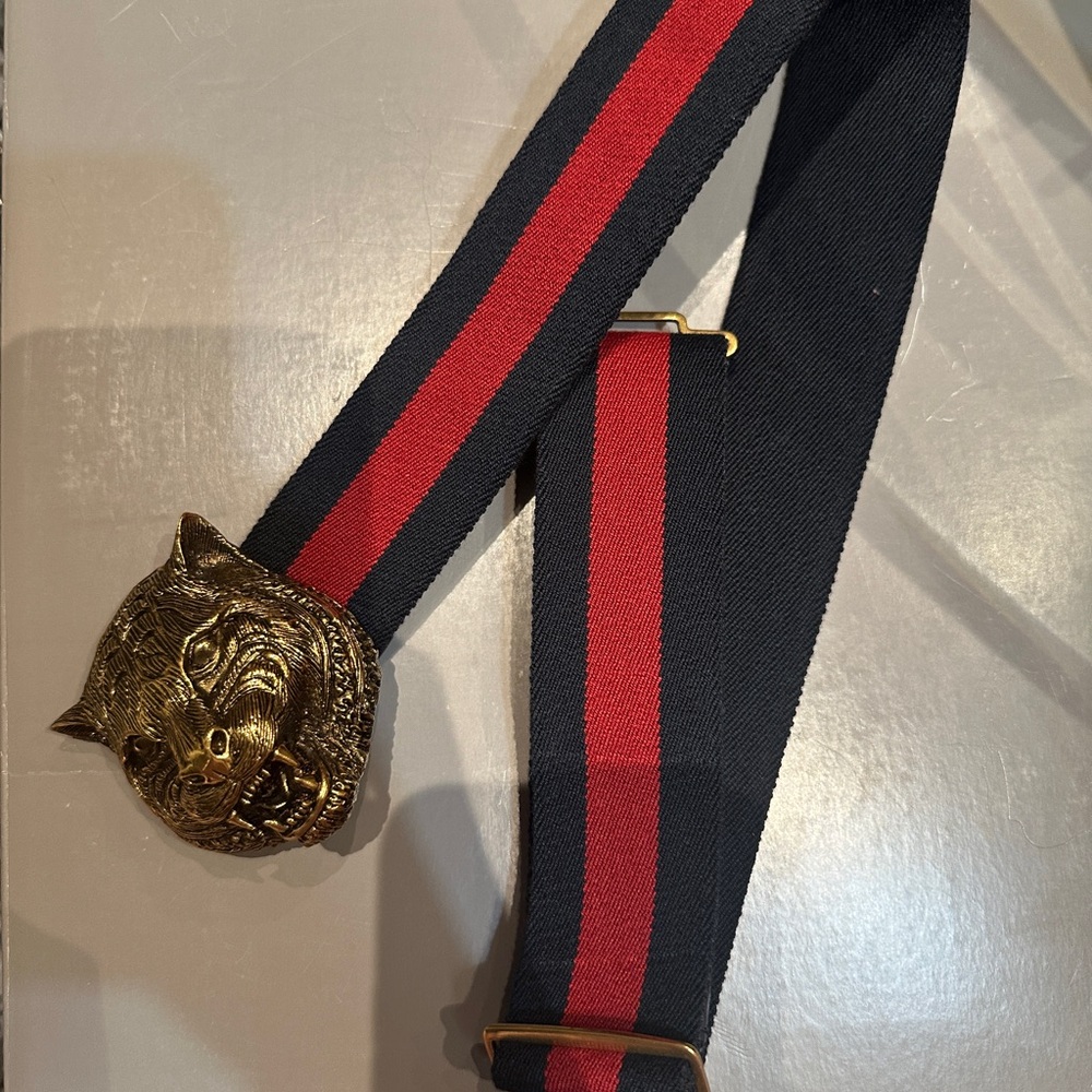 Blue and red Gucci web feline head belt.